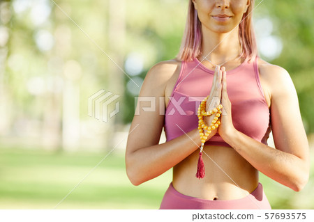 Woman practising yoga outdoors Woman practising yoga outdoors 57693575
