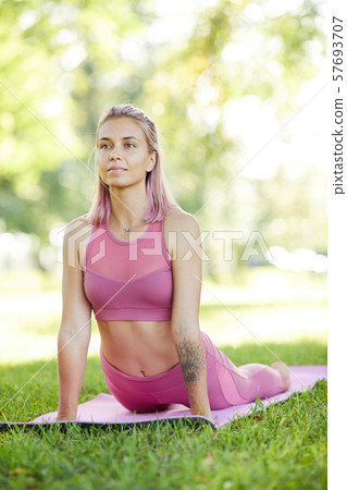Woman exercising in the park Woman exercising in the park 57693707