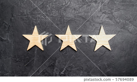 Three stars on a dark background. The concept of rating and evaluation of hotels, restaurants, mobile applications. Excellent quality, buyer choice. Good reviews and impeccable reputation. Three stars on a dark background. The concept of rating and evaluation of hotels, restaurants, mobile applications. Excellent quality, buyer choice. Good reviews and impeccable reputation. 57694089