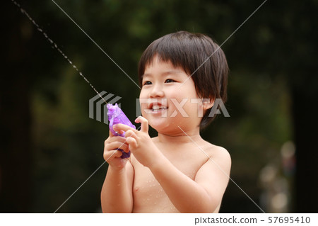Boys playing with water guns Boys playing with water guns 57695410