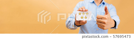 Web banner of Businessman showing five yellow stars card and thumbs up in bright color background 57695473