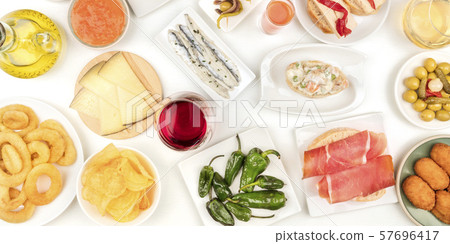 A panorama of Spanish tapas and wine, an overhead photo of a variety of snacks. Manchego cheese A panorama of Spanish tapas and wine, an overhead photo of a variety of snacks. Manchego cheese 57696417