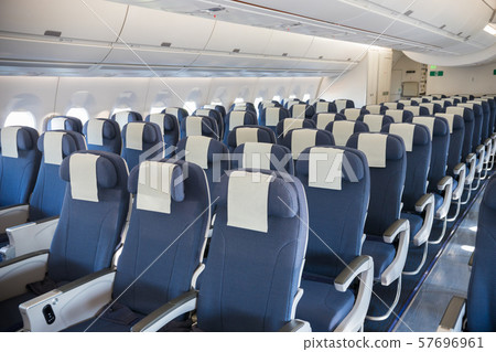 An economy class empty cabin of the airplane - empty dark blue chairs 57696961