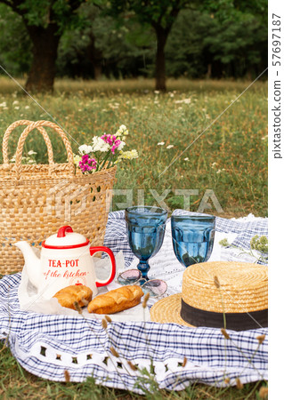 Stylish picnic on the green lawn. Fresh croissants Stylish picnic on the green lawn. Fresh croissants 57697187