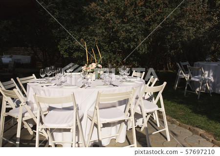 Wedding table setting decorated with fresh flowers 57697210