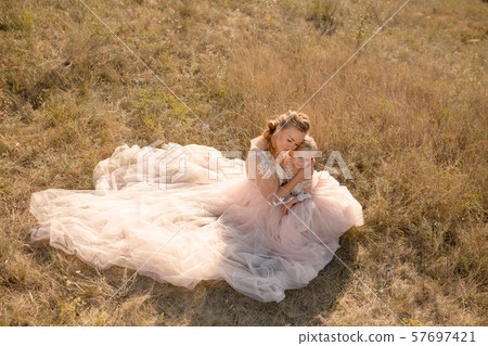 Young mother with a little daughter in pink Young mother with a little daughter in pink 57697421