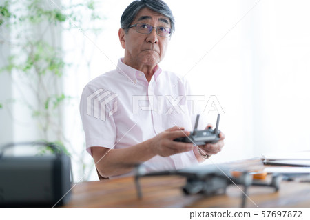 Drone controller 1 person hobby work home business old man old age interior design room 57697872