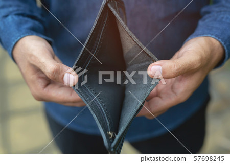 Empty wallet (no money) in the hands of an man. Empty wallet (no money) in the hands of an man. 57698245