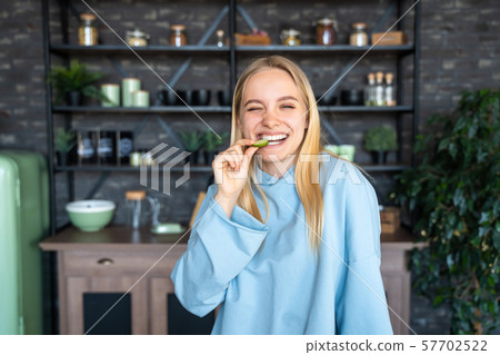 Beautiful young girl posing in the kitchen Beautiful young girl posing in the kitchen 57702522