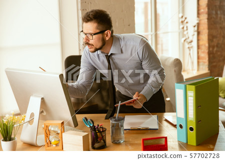 A young businessman moving in office, getting new work place 57702728