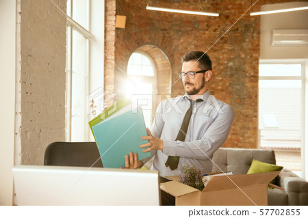A young businessman moving in office, getting new work place 57702855