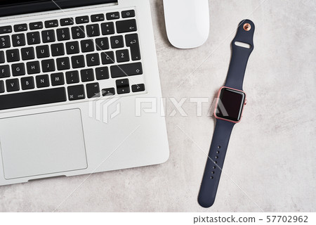 Open laptop with smartwatch on concrete background Open laptop with smartwatch on concrete background 57702962