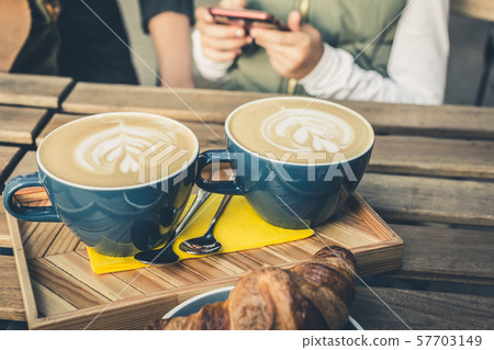 Two big cappuccino and croissant on a table 57703149