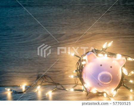 Pink piggy bank with Party lights, Enjoy savings for the holidays concept 57703525