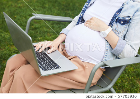 Pregnant woman using laptop for work Pregnant woman using laptop for work 57703930