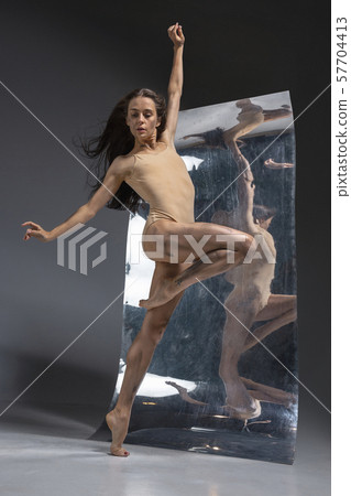Young and stylish modern ballet dancer on grey background 57704413