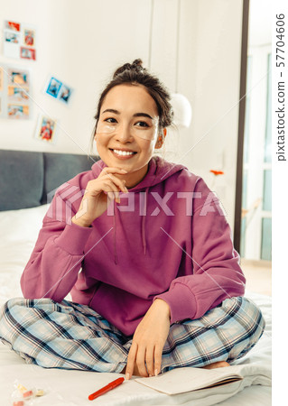 Smiling young woman taking care of her skin 57704606