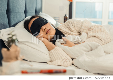 Beautiful young woman sleeping in her bed 57704663