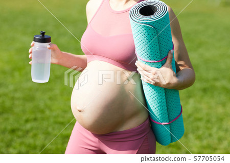 Pregnant woman exercising outdoors 57705054