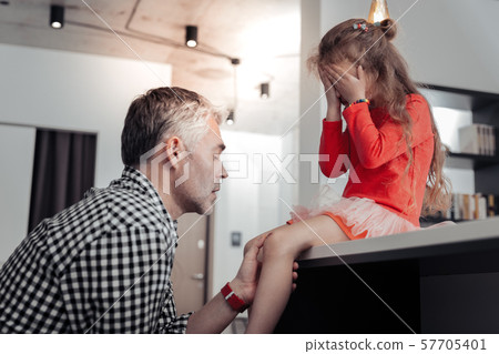 Negative delighted girl covering her face while crying 57705401