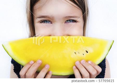 Happy girl holding watermelon slice close up 57705615
