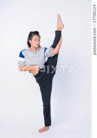 Full body shot of beautiful Asian woman stretching and ready for gym 57706124