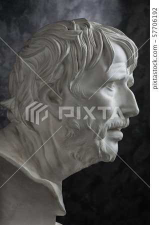 Gypsum copy of ancient statue Seneca head on dark textured background. Plaster sculpture man face. Gypsum copy of ancient statue Seneca head on dark textured background. Plaster sculpture man face. 57706192