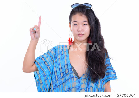 Portrait of beautiful Asian tourist woman pointing up ready for vacation 57706364