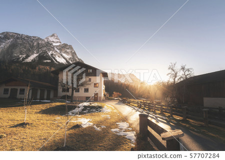 Winter scenery with the snowy Alps and alpine farm Winter scenery with the snowy Alps and alpine farm 57707284