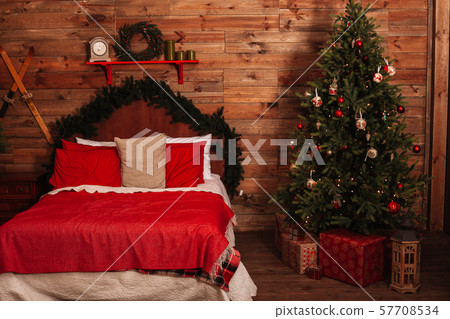 A cozy large double bed next to the Christmas tree 57708534