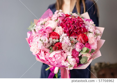 Pink peonies and red hydrangea. Beautiful bouquet of mixed flowers in woman hand. Floral shop Pink peonies and red hydrangea. Beautiful bouquet of mixed flowers in woman hand. Floral shop 57708962
