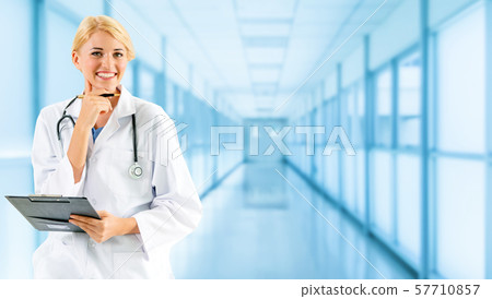 Woman doctor working at the hospital office. 57710857