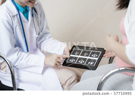 Pregnant Woman and Gynecologist Doctor at Hospital Pregnant Woman and Gynecologist Doctor at Hospital 57710995