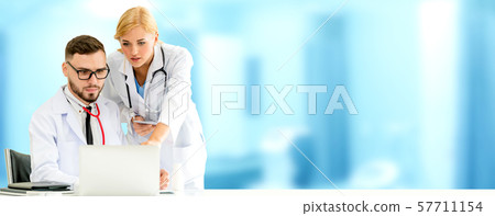 Doctors working with laptop computer in hospital. Doctors working with laptop computer in hospital. 57711154