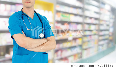 Male pharmacist working at the pharmacy. 57711155
