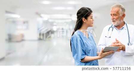 Senior and young doctor working in the hospital. Senior and young doctor working in the hospital. 57711156