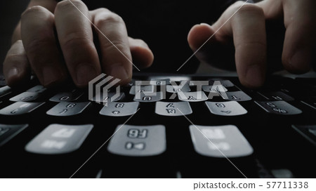 Close-up soft-focus finger typing on keyboard. 57711338