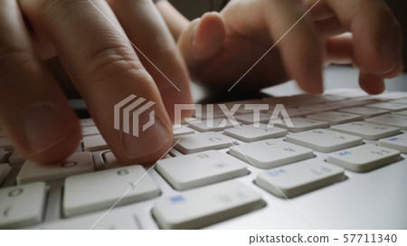 Close-up soft-focus finger typing on keyboard. Close-up soft-focus finger typing on keyboard. 57711340
