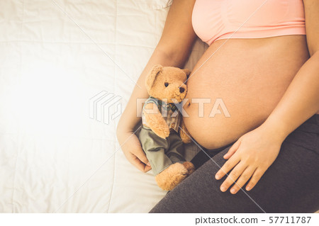 Happy pregnant woman and expecting baby at home. 57711787
