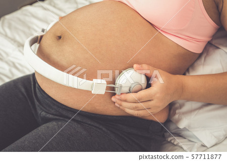 Happy pregnant woman and expecting baby at home. Happy pregnant woman and expecting baby at home. 57711877