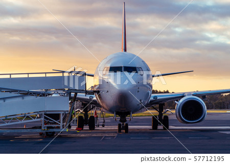 Airplane on Airport Runway at Sunset in Tasmania 57712195