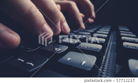 Close-up soft-focus finger typing on keyboard. Close-up soft-focus finger typing on keyboard. 57712217