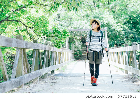 Trekking young woman Trekking young woman 57713615