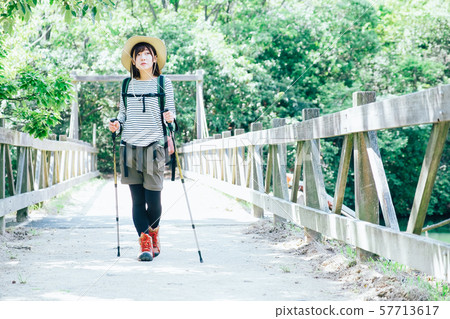 Trekking young woman Trekking young woman 57713617