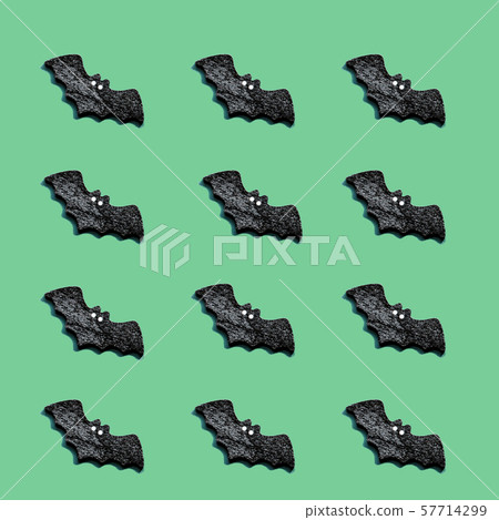 A lot of black bats on a green background 57714299