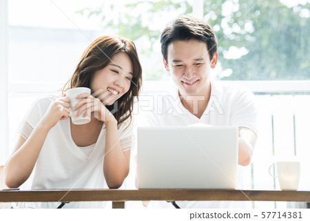 Couple searching on laptop 57714381