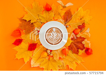 Coffee latte cup in dry autumn leaves wreath frame Coffee latte cup in dry autumn leaves wreath frame 57715794