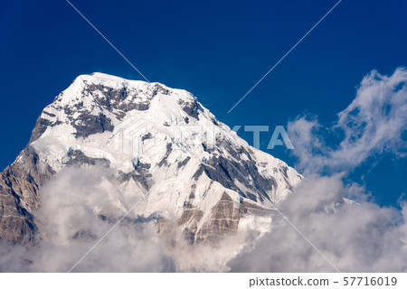 Annapurna South mountain peak with blue sky Annapurna South mountain peak with blue sky 57716019