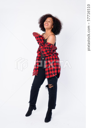 Full body shot of happy young beautiful African hipster woman smiling Full body shot of happy young beautiful African hipster woman smiling 57716510