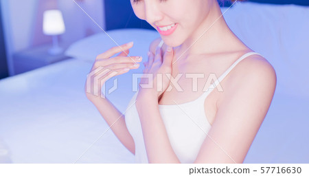 woman apply cream with chest woman apply cream with chest 57716630